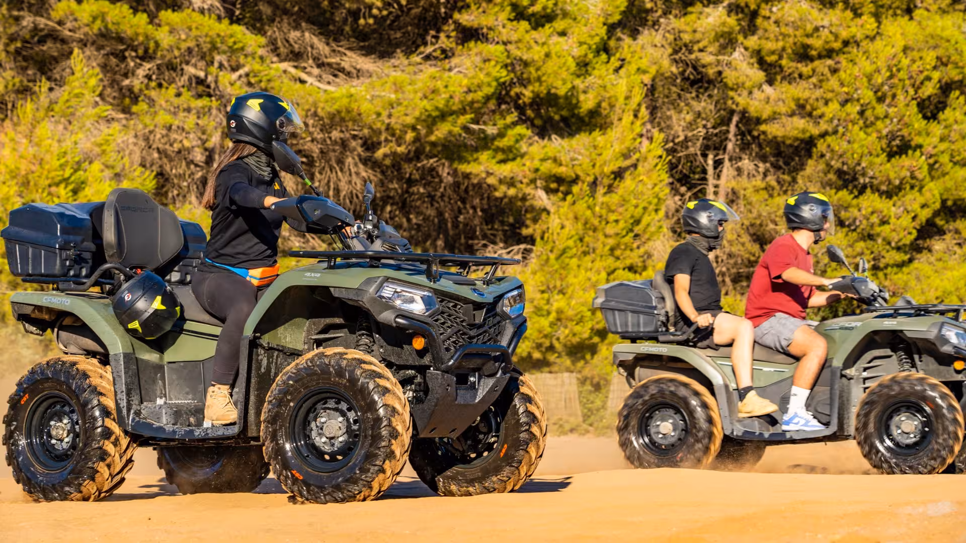 Group enjoying thrilling ATV ride through lush Costa Verde landscape on Arbus excursion adventure.