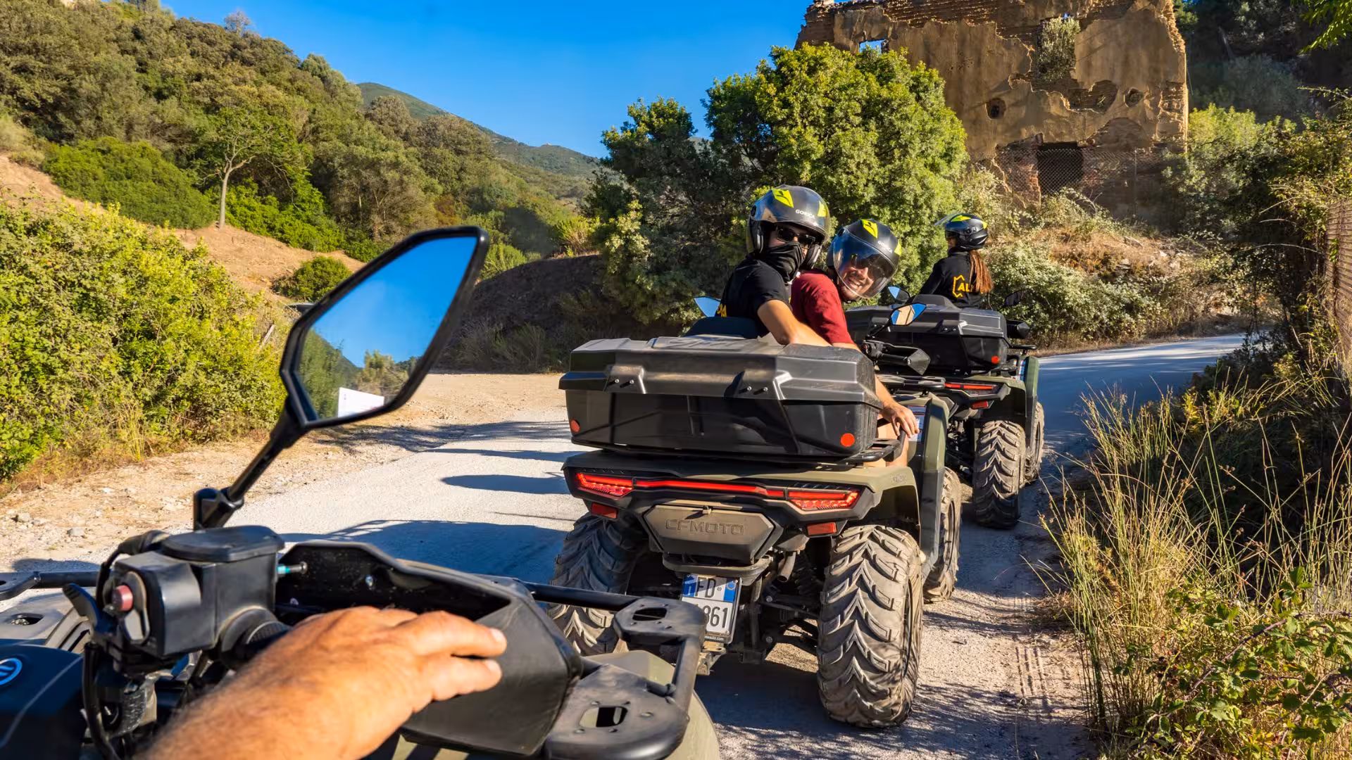 ATV riders exploring lush trails in Costa Verde on a sunny day during the Arbus excursion tour.