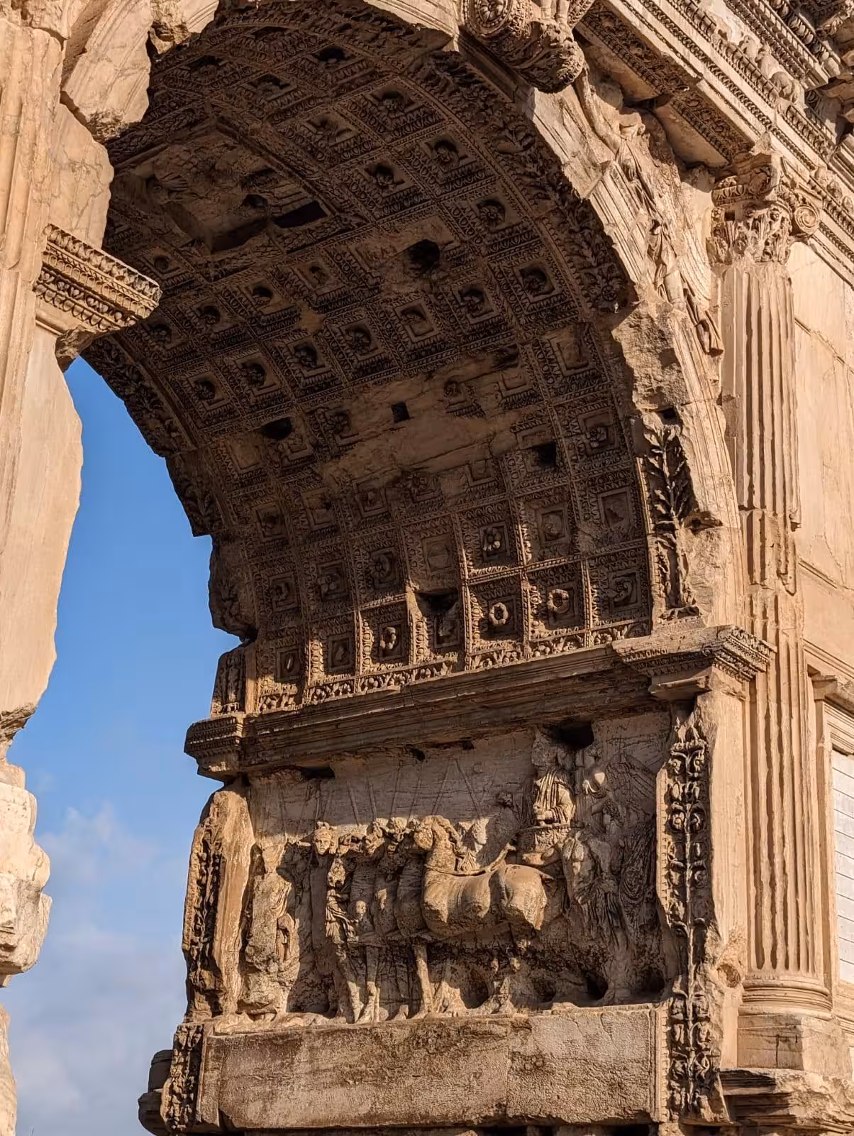 Detailed close-up of the Arch of Titus in Rome, featuring intricate ancient Roman carvings and architecture.