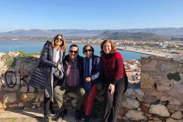 Private Argolis full-day tour guests at Palamidi Fortress viewpoint overlooking Nafplio harbor and mountains
