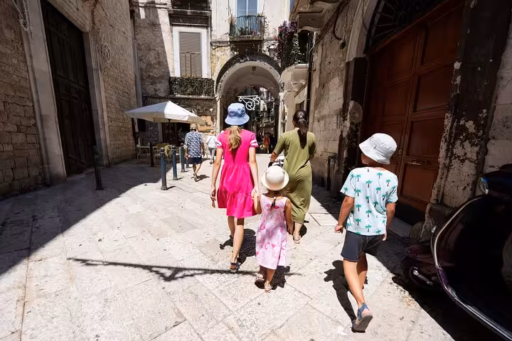 Family strolling through picturesque streets of Arles during a guided walking tour, enjoying the historic ambiance.
