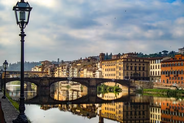 Arno River and historic Florence architecture reflecting picturesque views on a Rome to Florence day trip.