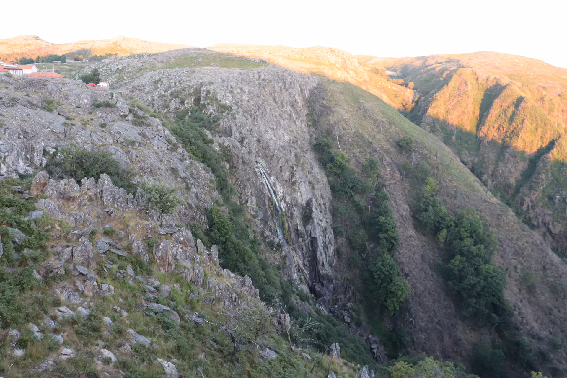 Scenic view of rugged cliffs and lush greenery near Arouca 516 Bridge, perfect for adventurous Paiva Walkways tour.