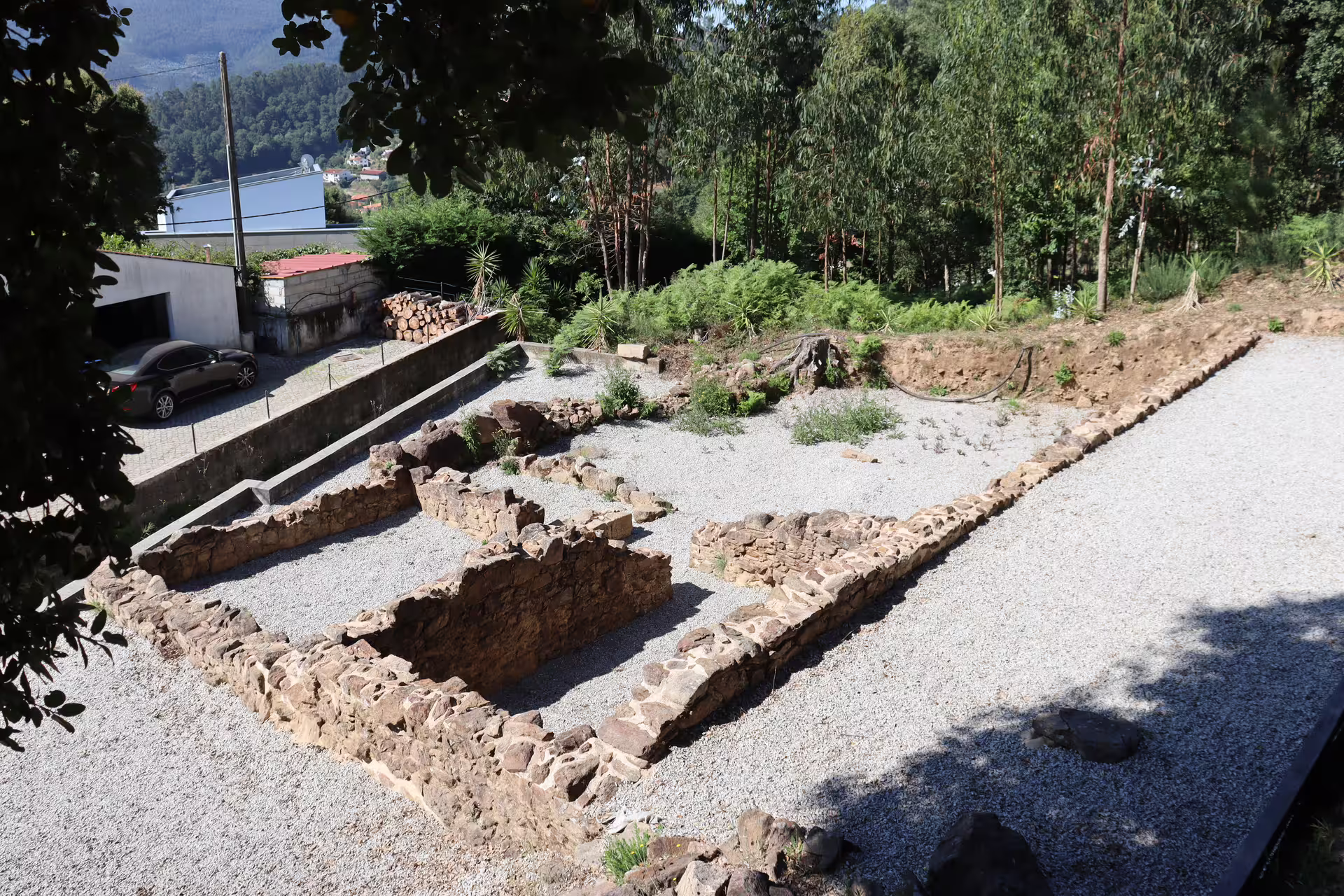 Ancient stone ruins surrounded by lush greenery near Arouca 516 Bridge and Paiva Walkways, perfect for a scenic private tour.