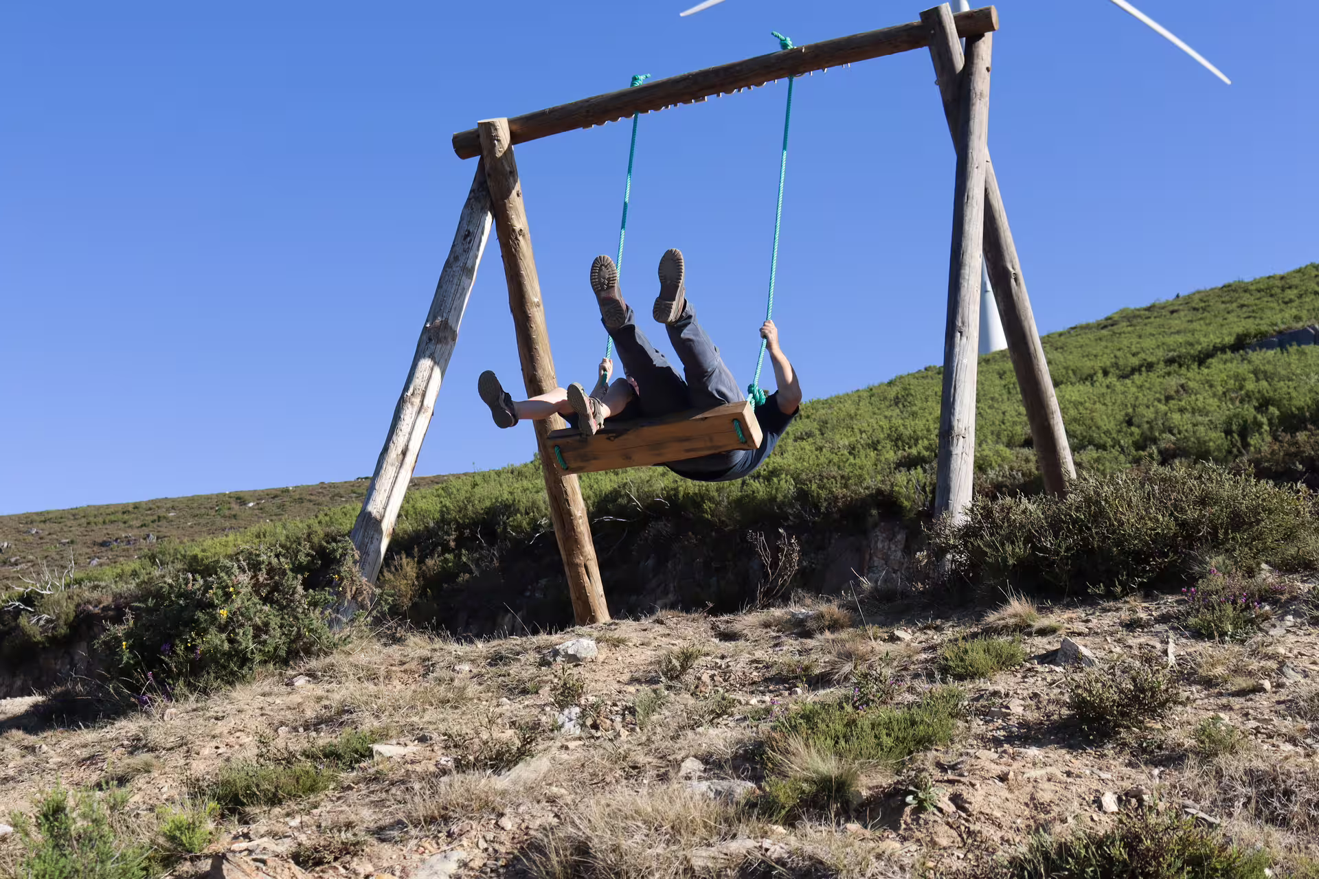 Person enjoying a wooden swing with scenic views near Arouca 516 Bridge on a private tour of the Paiva Walkways.