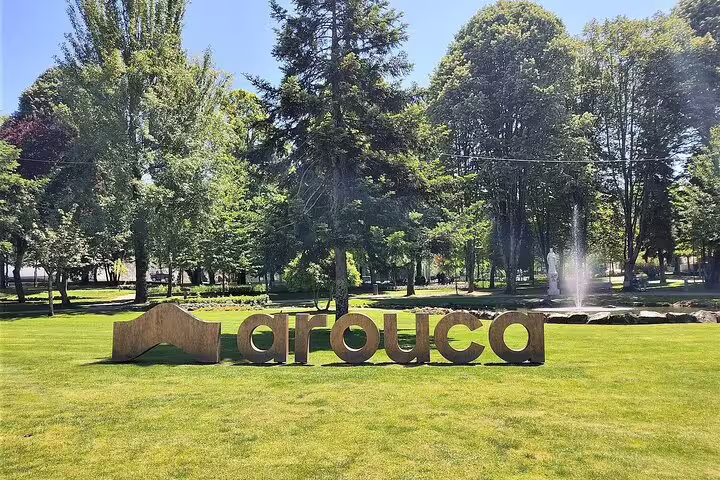 Arouca sign in a lush green park with trees and a fountain, perfect for visitors exploring Paiva Walkways and Arouca Suspension Bridge.