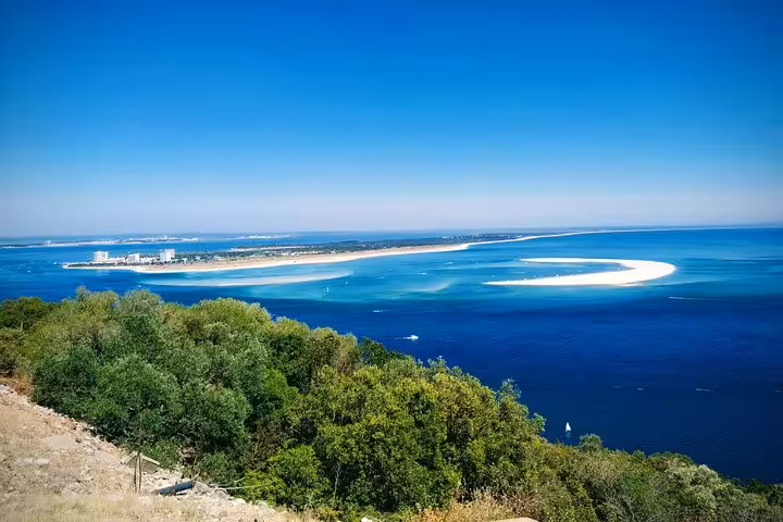 Breathtaking panorama of Arrábida coastline showcasing vibrant blue waters and lush green landscapes.