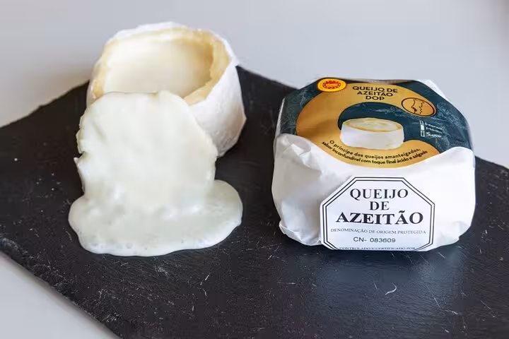 Delicious Queijo de Azeitão cheese displayed on a slate board, perfect for tasting during an Arrábida winery tour.