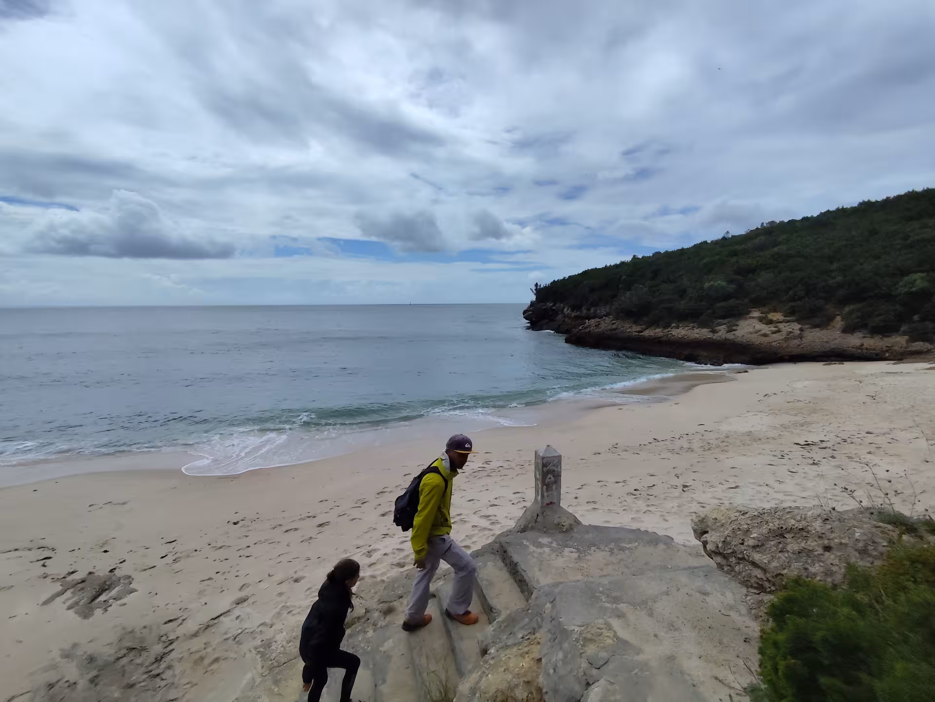 Hikers overlooking a secluded Arrábida beach and cliffs on an Arrábida Safari Tour coastal adventure in Portugal