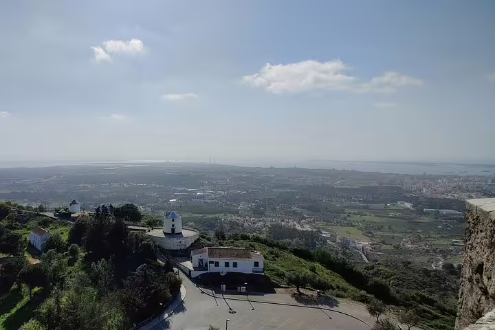 Scenic view from a hilltop in Arrabida, showcasing lush landscapes and ocean vistas on a Lisbon day tour with wine tasting.