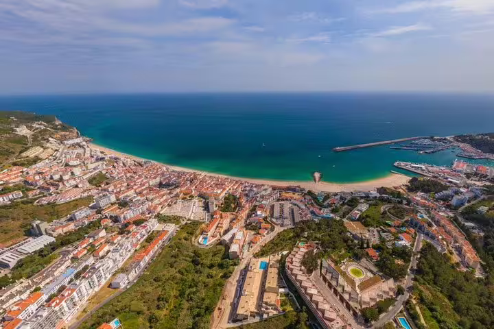Aerial view of Setúbal's stunning coastline and vibrant cityscape, perfect for exploring on an Arrábida private tour.