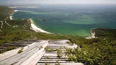 Panoramic view from Arrábida viewpoint over green Atlantic waters, wild beaches and coastal hiking trails near Setúbal