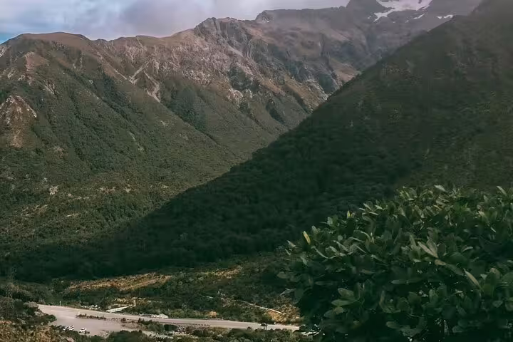 Lush green mountains and winding roads in Arthur's Pass, ideal for a scenic private alpine vista day tour experience.