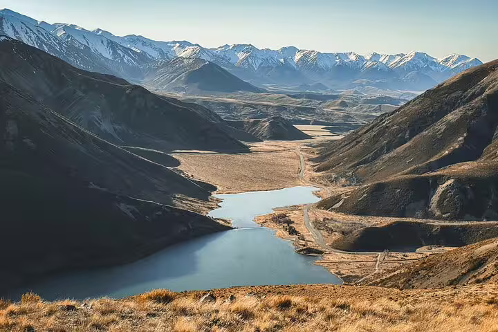 Stunning view of snow-capped mountains and a serene lake in Arthur's Pass, perfect for a private alpine vista day tour.