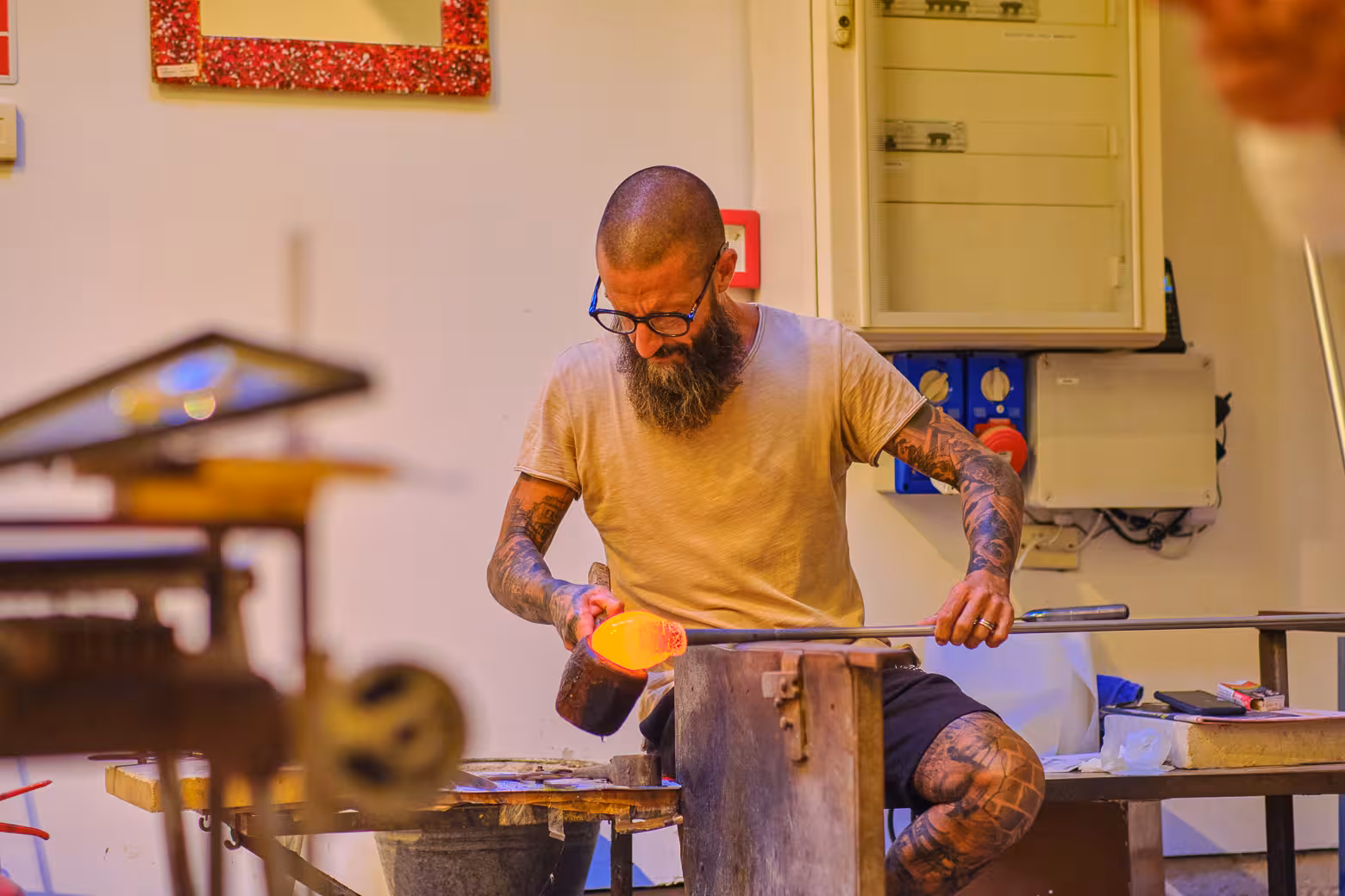Skilled artisan crafting glass in Venice workshop, highlighting traditional craftsmanship on Florence to Venice tour.