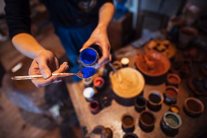 Close-up of artist mixing blue pigment, like Van Gogh, on a private Rembrandt & Van Gogh walking tour