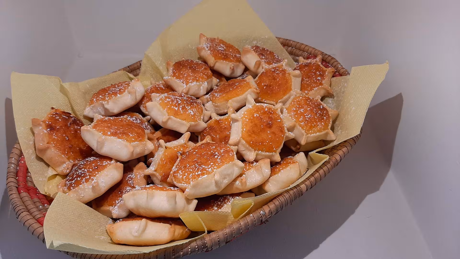 Basket of traditional pastries dusted with sugar, part of the Arzana shepherd farm lunch tour.