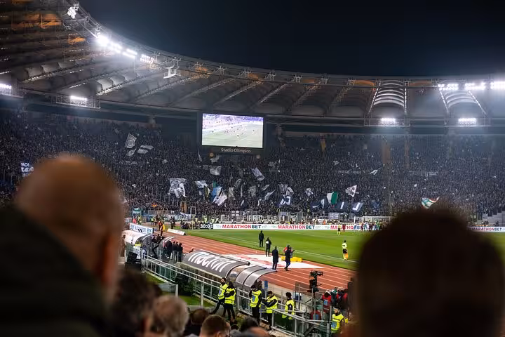 Stadio Olimpico night match crowd on AS Roma or Lazio game tour in Rome with local host and tickets