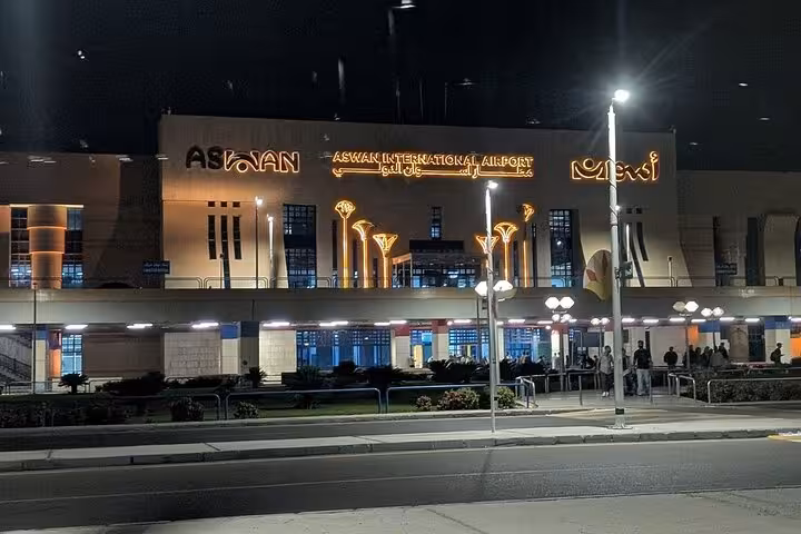 Aswan International Airport at night with illuminated entrance, ideal pickup point for private Aswan airport transfer