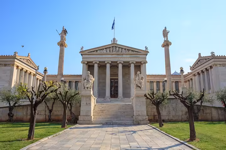 Front view of the historic Athens Academy, showcasing its grand neoclassical architecture on a sunny day.