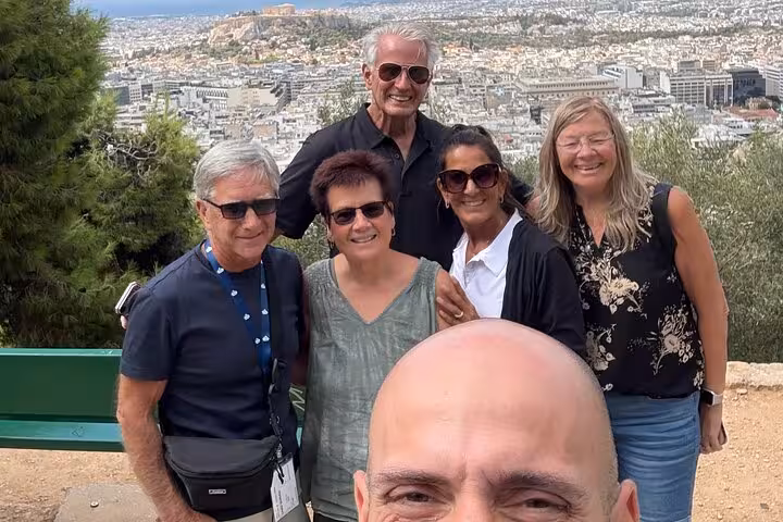 Private Athens Acropolis city tour group photo at viewpoint with panoramic Athens skyline in background