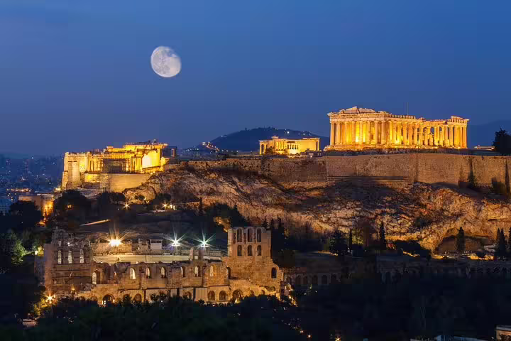 Night view of the illuminated Acropolis and Parthenon with moon, perfect for a full-day private Athens tour