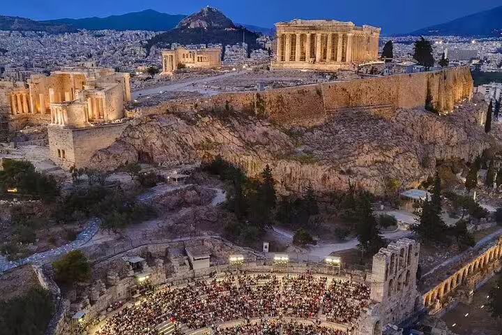 Evening view of Athens Acropolis and Odeon, ideal for private transfer from Athens center to Piraeus Port