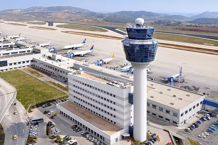 Aerial view of Athens Airport control tower and runway, pickup for luxury private transfer to Piraeus Port