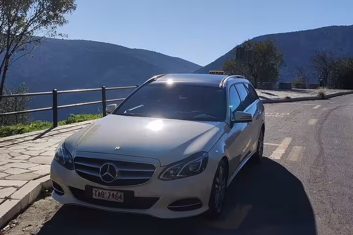 Private luxury Mercedes sedan for Athens Airport to Piraeus Port transfer, scenic coastal road pickup