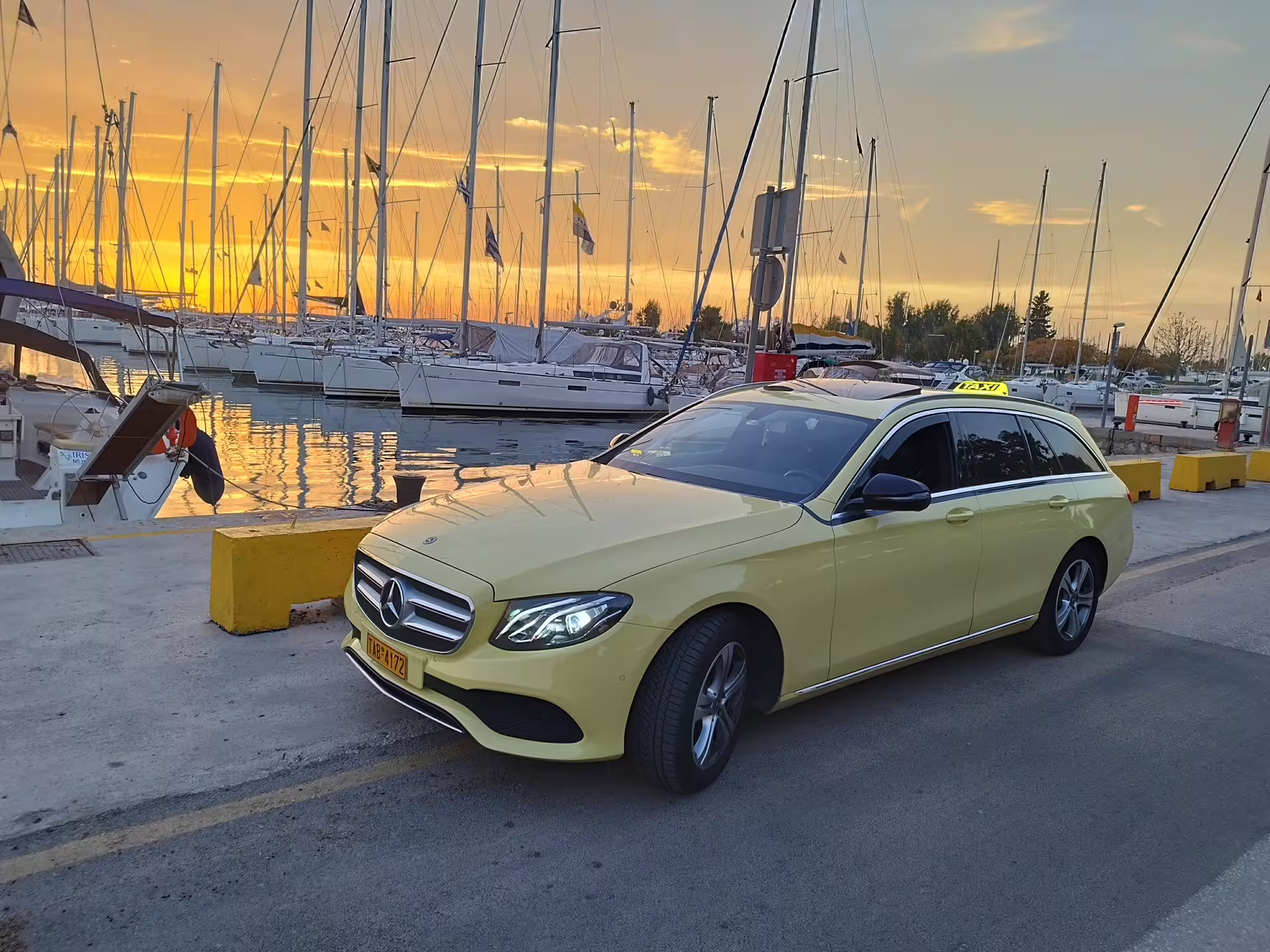 Private Athens airport to Piraeus Port transfer taxi by marina at sunset, reliable cruise port pickup