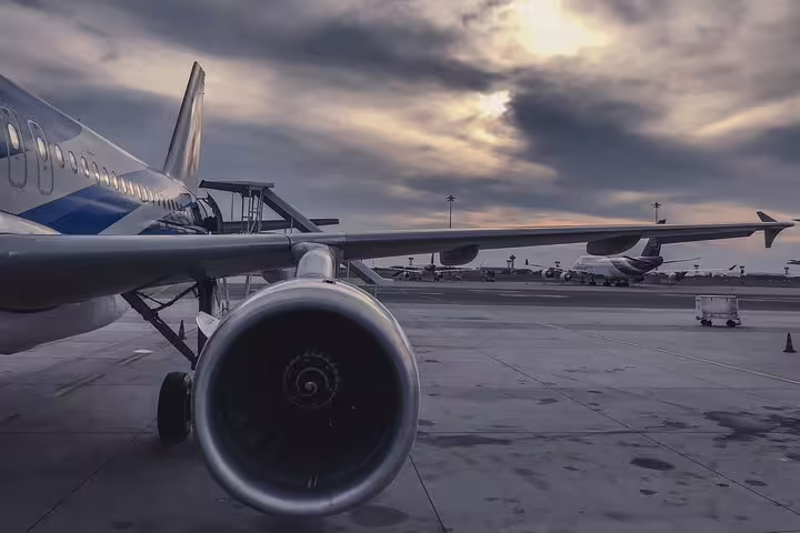 Airplane on Athens airport tarmac at sunset, ideal for booking a private arrival transfer to Athens city center