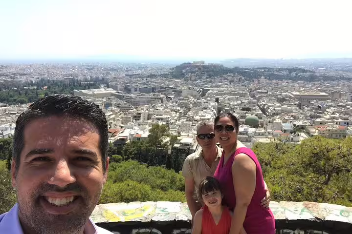 Family at Athens panoramic viewpoint on private transfer with 1-hour tour of must-see city sights from airport or port