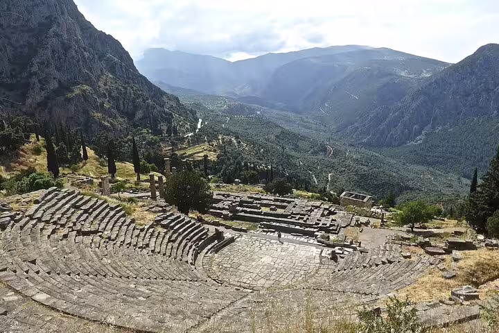 Breathtaking view of the ancient theatre at Delphi with mountainous backdrop on a private tour from Athens.