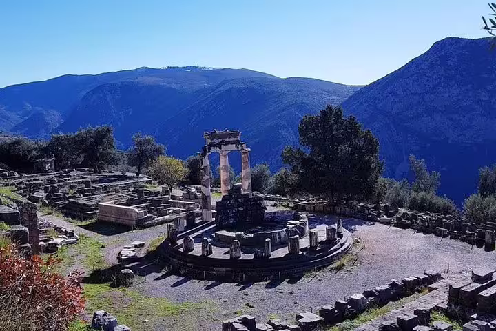 Delphi archaeological site with Tholos of Athena Pronaia, scenic stop on private Athens to Delphi transfer