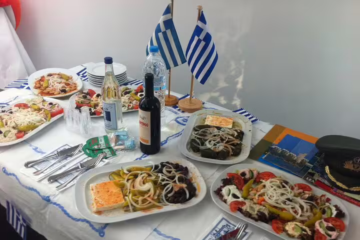 Greek meze spread with wine and flags, ideal add-on taste on a 2-hour private Athens highlights express tour