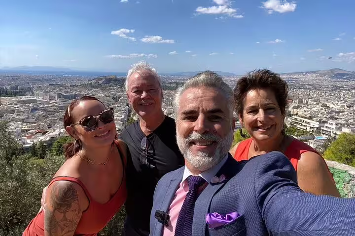 Private Athens half-day tour group selfie with local guide and panoramic city views from Lycabettus Hill