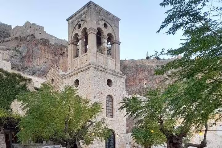 Historic stone church with bell tower near the Acropolis, seen on an Athens half-day private car tour