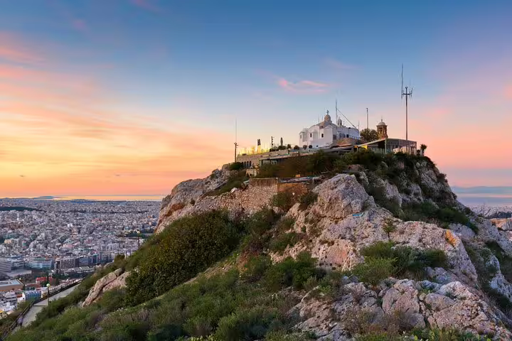 Sunset view from Lycabettus Hill in Athens on a full-day private tour, with chapel and city panorama