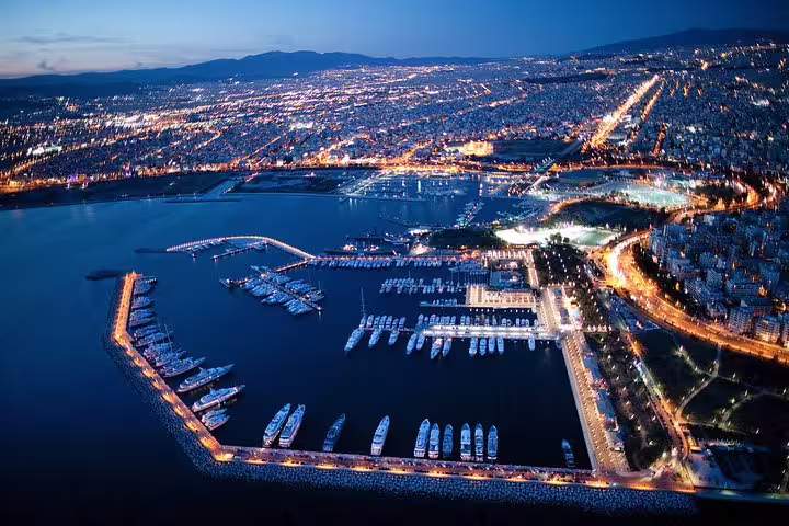 Aerial night view of Athens marina and coastline, ideal start for a private Cape Sounion sunset tour