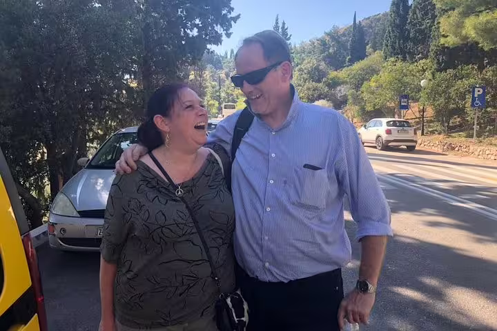 Happy couple with driver on private Athens to Peloponnese and Nafplio day tour, scenic Greek countryside