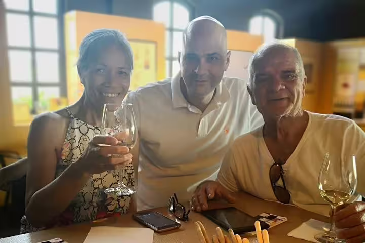 Travelers enjoying Greek wine tasting on a private Athens to Peloponnese day trip with Nafplio stop