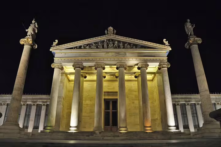 Illuminated Academy of Athens at night on small group sightseeing tour with drinks and Greek food tasting