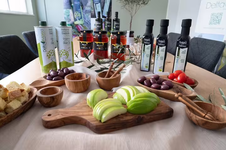 Olive oil tasting setup in Athens with Greek extra virgin olive oils, olives, bread, and fresh tomato samples