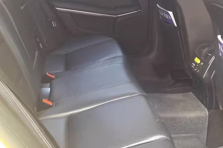 Spacious leather rear seats in private sedan for Athens to Ancient Olympia transfer, air-conditioned comfort