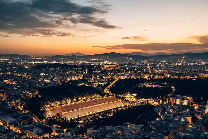 Athens panoramic night view at sunset with illuminated Panathenaic Stadium on small group city tour