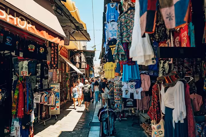 Shopping lane in Athens Plaka market with hanging souvenirs, part of small group walking and tasting tour