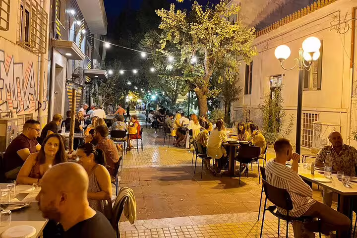 Athens Plaka nightlife with outdoor tavernas and string lights, featured on a half-day private city tour
