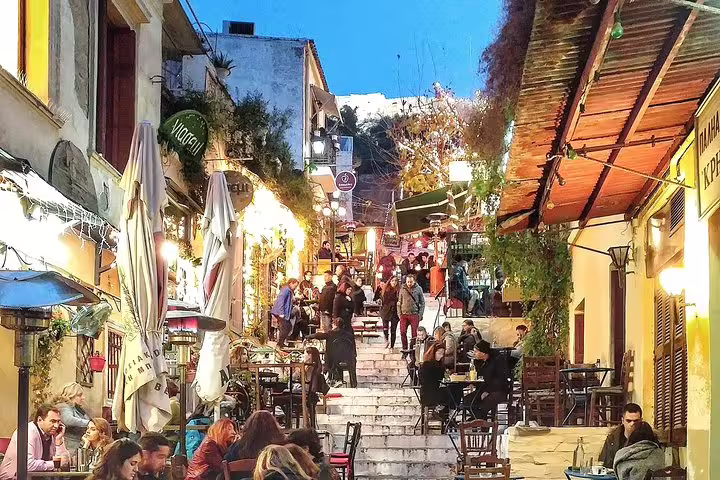 Lively Plaka steps with tavernas at dusk in Athens, seen on a guided walking tour with Acropolis skip-the-line ticket