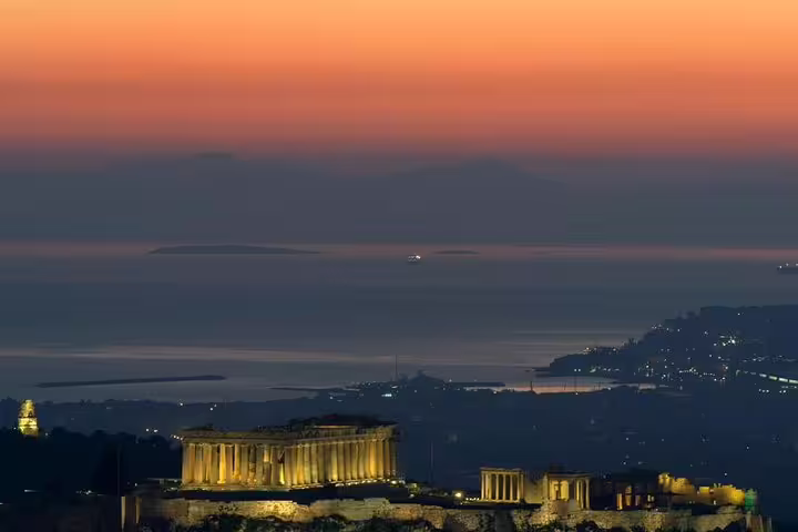 Sunset view over Athens with lit Temple of Poseidon at Cape Sounio, extension from private city tour