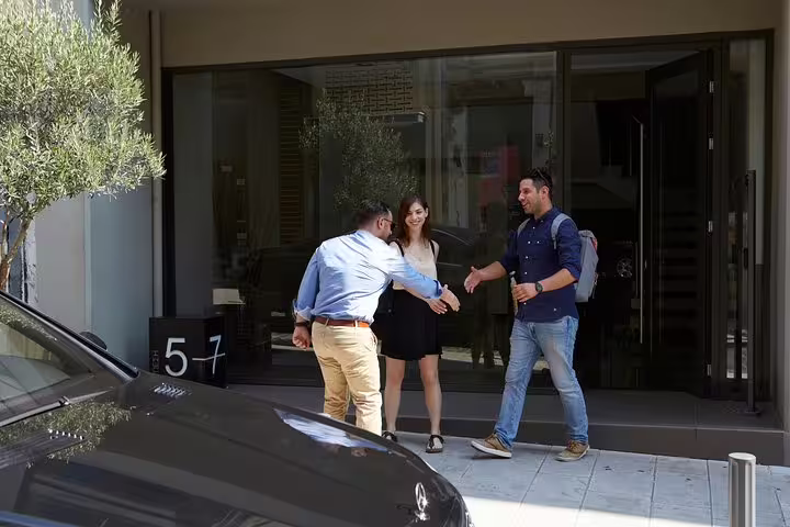 Driver greeting guests at hotel pickup for The Best of Athens private half-day sightseeing ride in Athens
